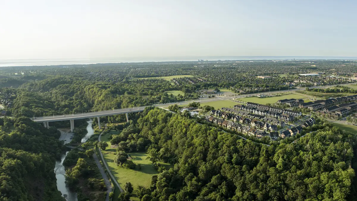 Aerial rendering of Five Oaks beside the Sixteen Mile Creek valley and the Dundas Street bridge in Oakville